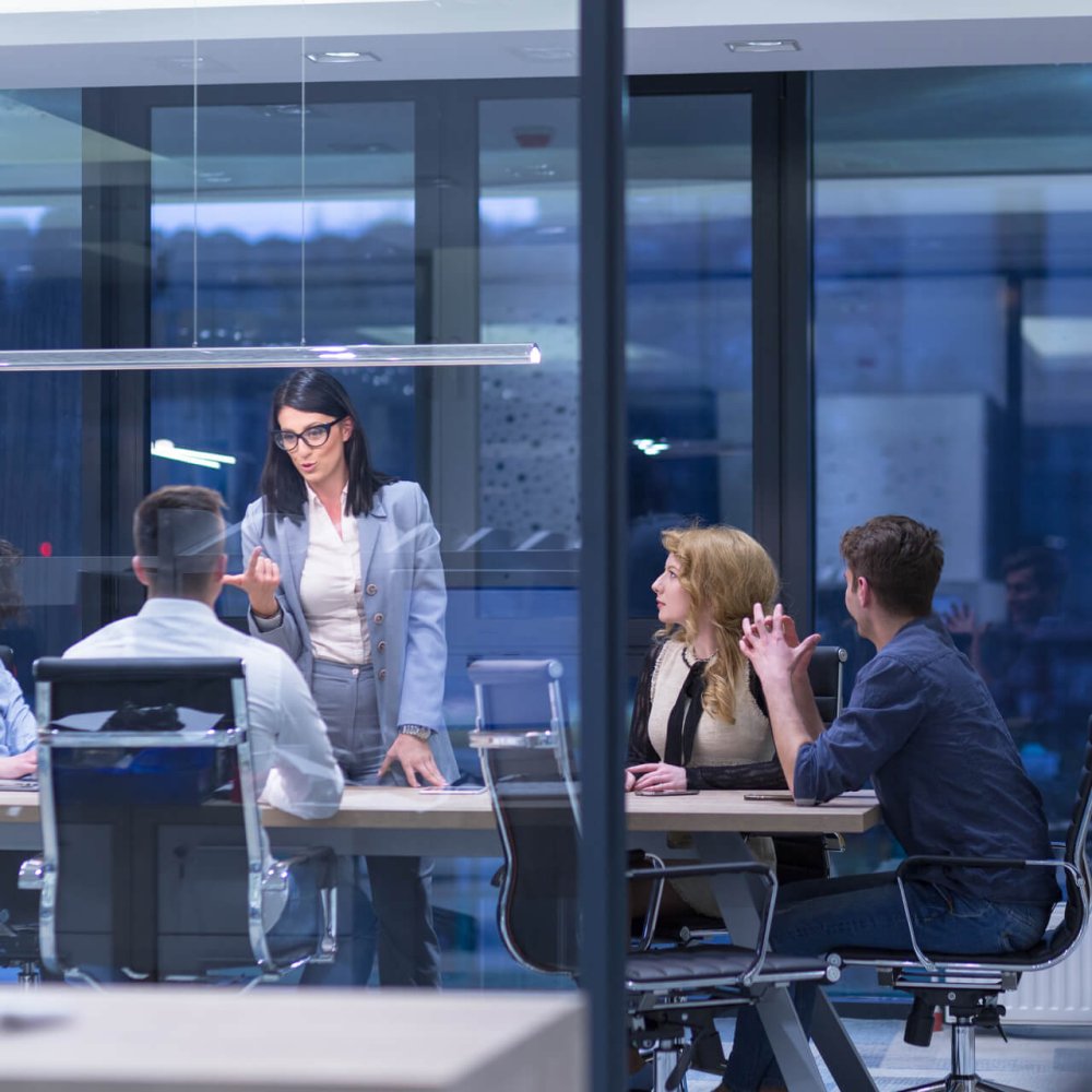 Group of a young business people discussing business plan at modern startup office building